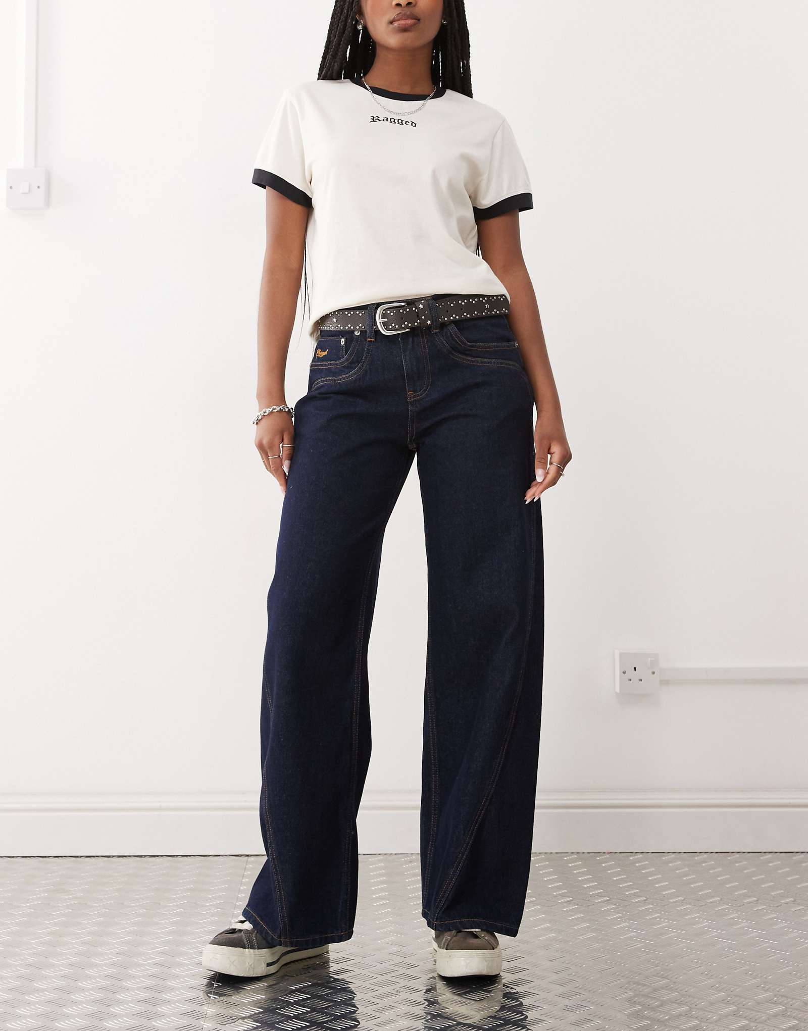 Оборванный священник в мешковатых джинсах цвета индиго с низкой посадкой