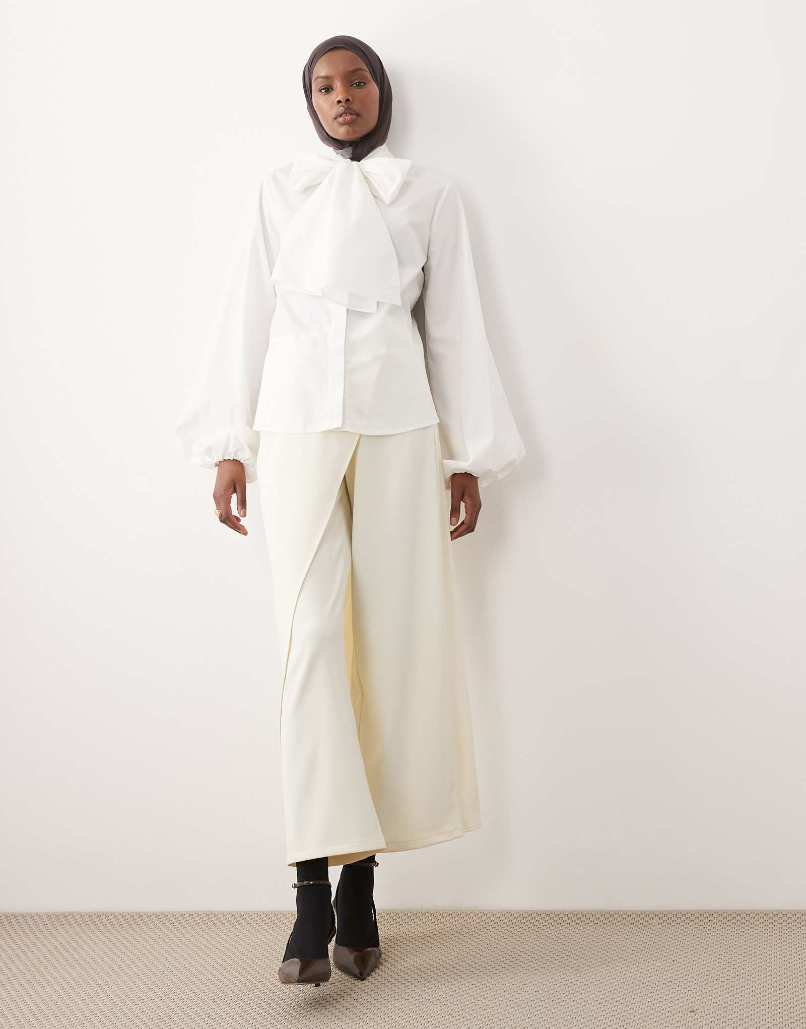 IYAL pants with wrap over skirt button detail in cream cream