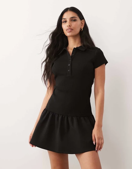 Мини-платье-поло с баской на подоле из гибридной ткани ASOS DESIGN, выполненное в черном цвете