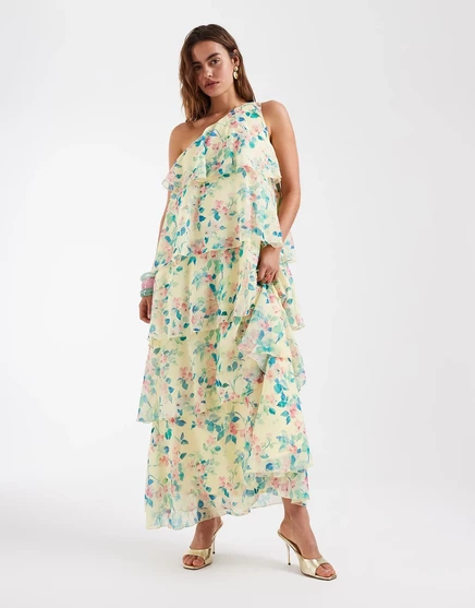 Многоярусное макси-платье Vero Moda Felicia на одно плечо с рюшами и цветочным принтом по бокам на желтой основе.