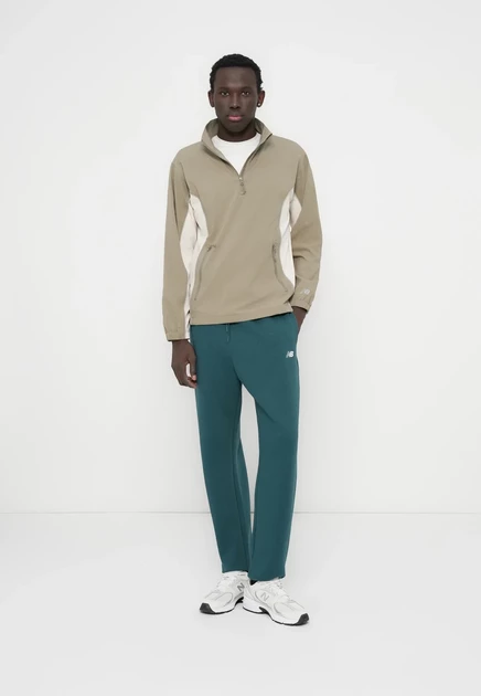 New Balance SPORT ESSENTIALS JOGGER - Tracksuit bottoms - sport green medusa green